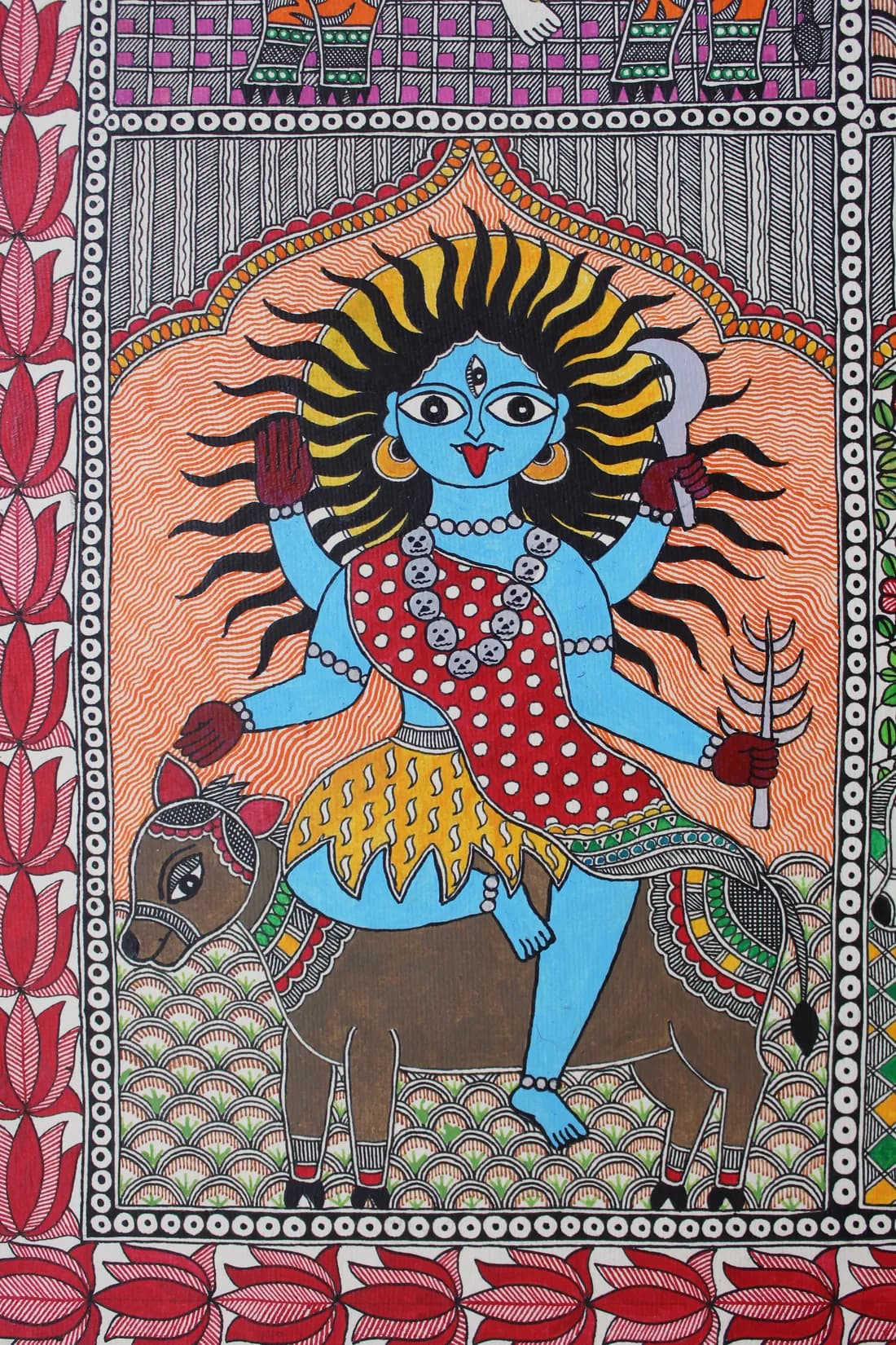 Madhubani painting of a fierce blue-skinned goddess with flame-like hair and a skull garland, seated on a horned animal