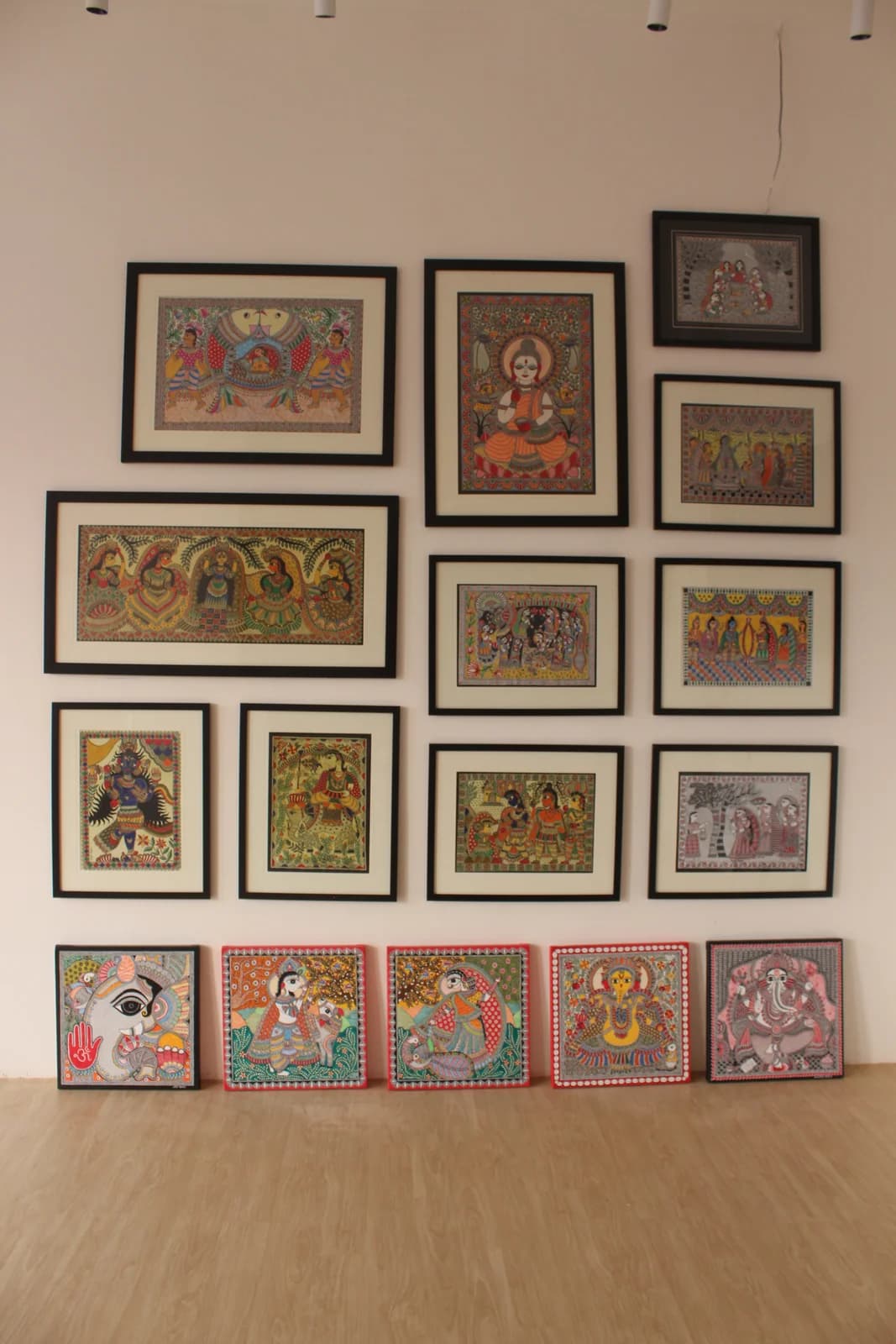 Gallery wall inside Nirala Studio in Puri, densely hung floor to ceiling with framed Madhubani (Mithila) paintings